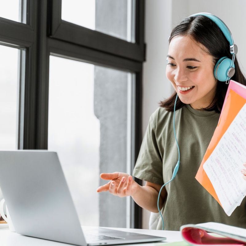 woman-with-headphones-having-video-call-laptop